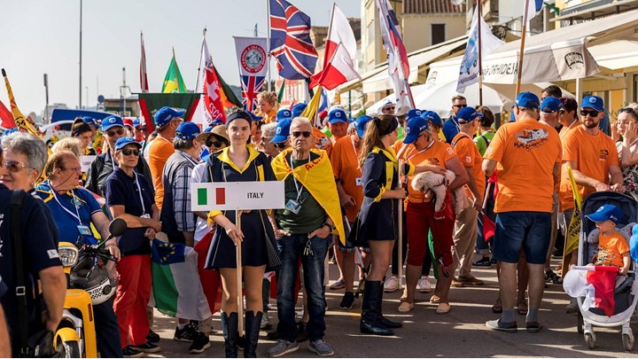 A group of people holding various national flags at an outdoor event