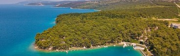 Aerial view of a forested coastline on the island of Cres with turquoise sea